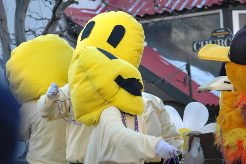 a man dressed as a bird walking in a parade