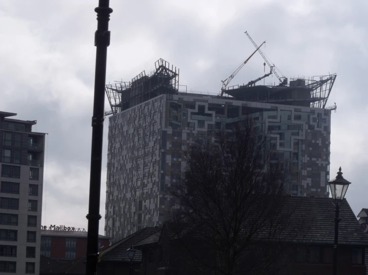 some very large buildings with a clock and street lamp