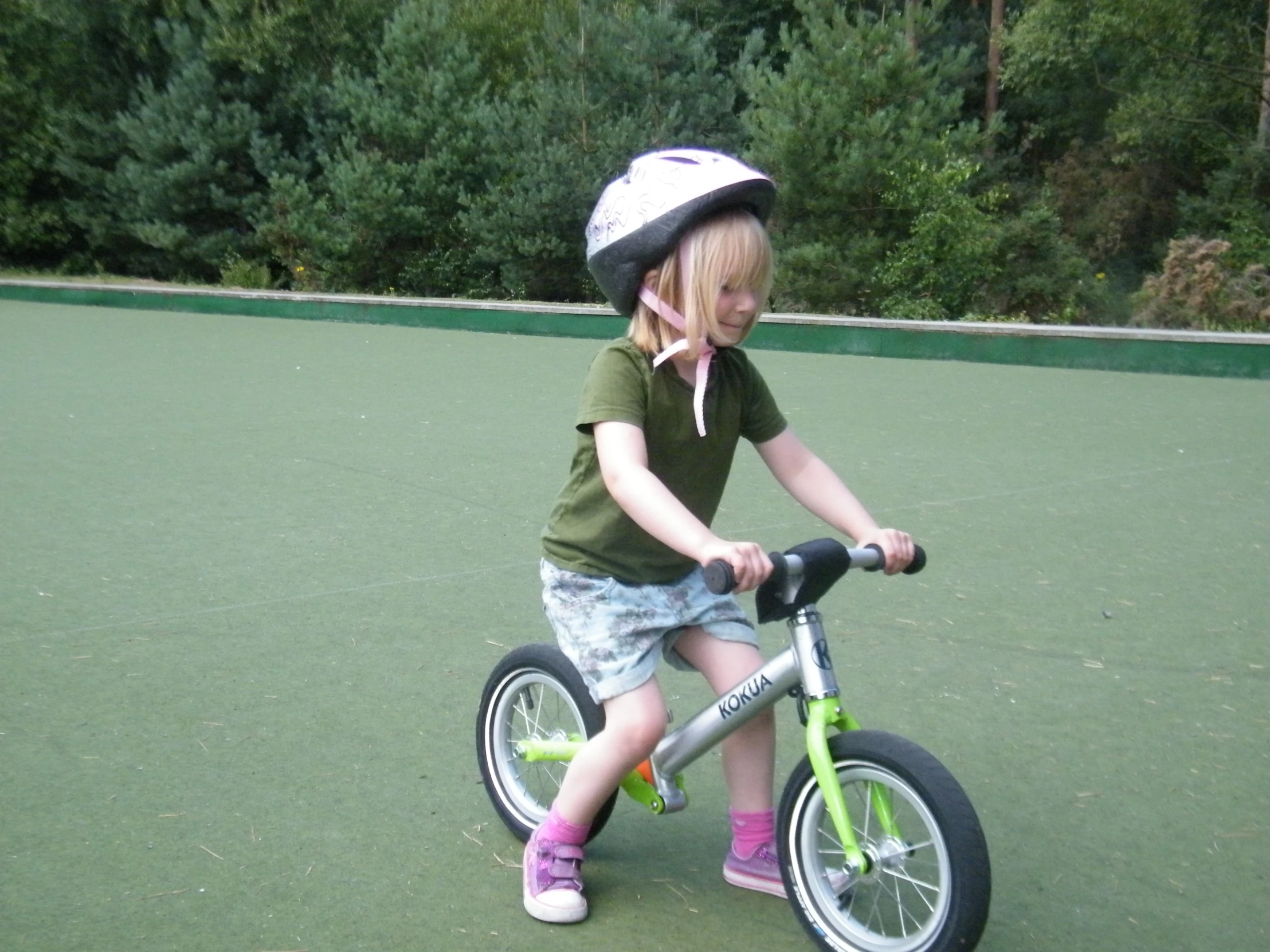 a  riding on top of a bike