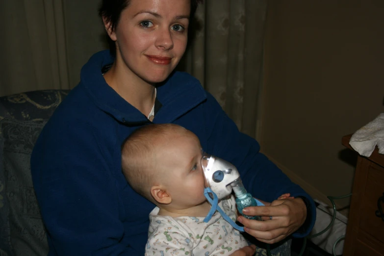 a baby is drinking from a toy bottle