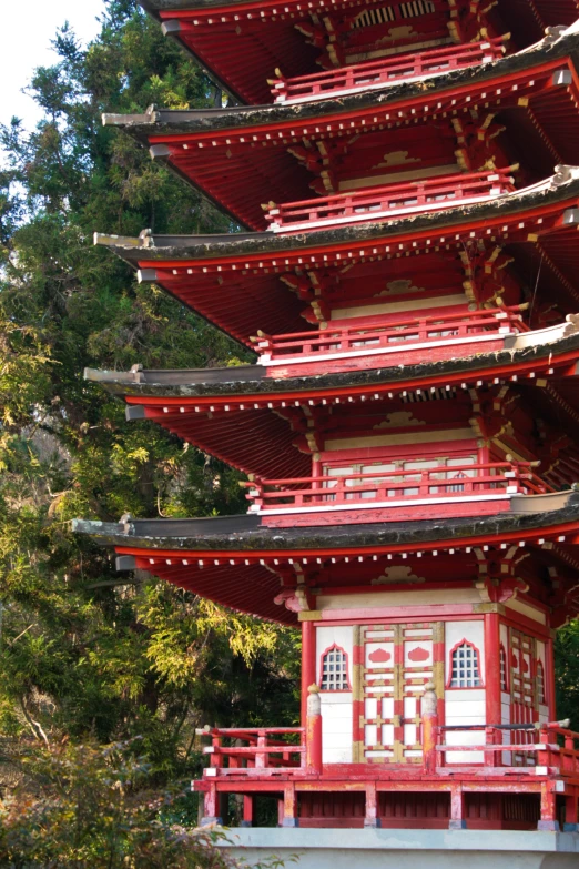 a very tall building that has a wooden ceiling and red railing