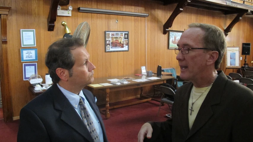 two people talk inside a courtroom or courtroom