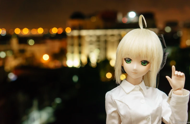 doll holding a finger on her left hand in front of a night scene