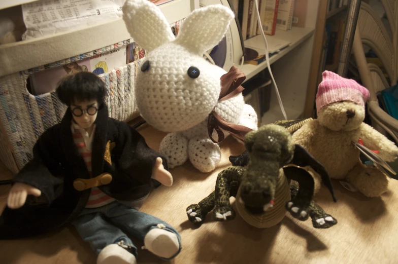 some people sit on the floor with a lot of stuffed animals