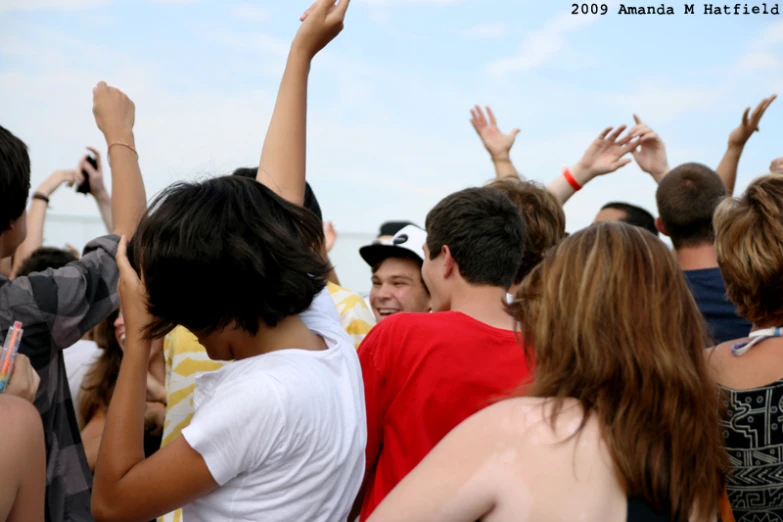 a bunch of people at an event with arms up