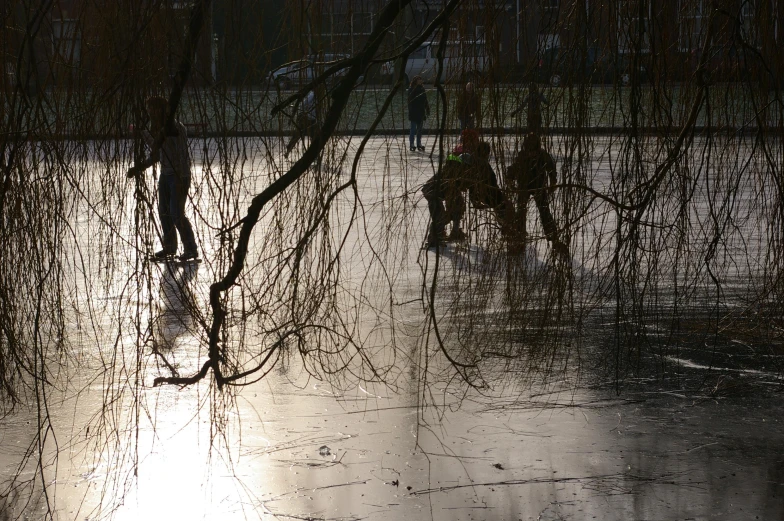 people are riding boards in the water at night