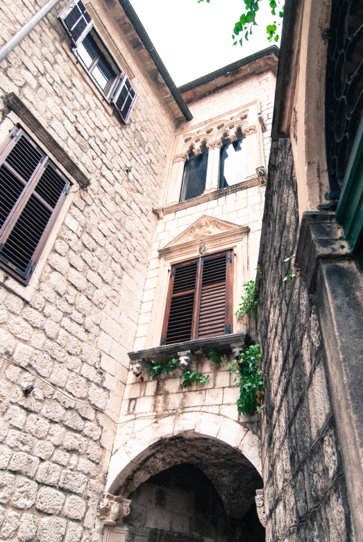 a view of a stone building with some windows