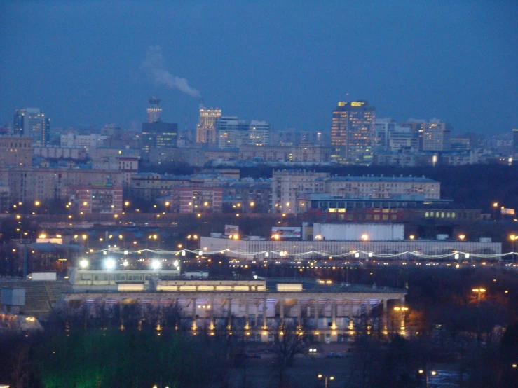 a city skyline at night with lights on