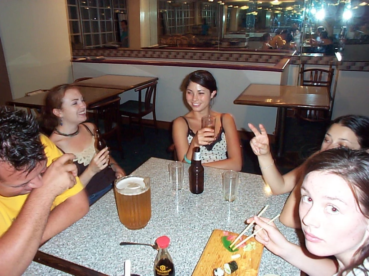 four people sitting at a table with plates of food