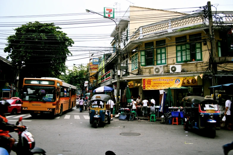 the street market area has an assortment of produce and people on it