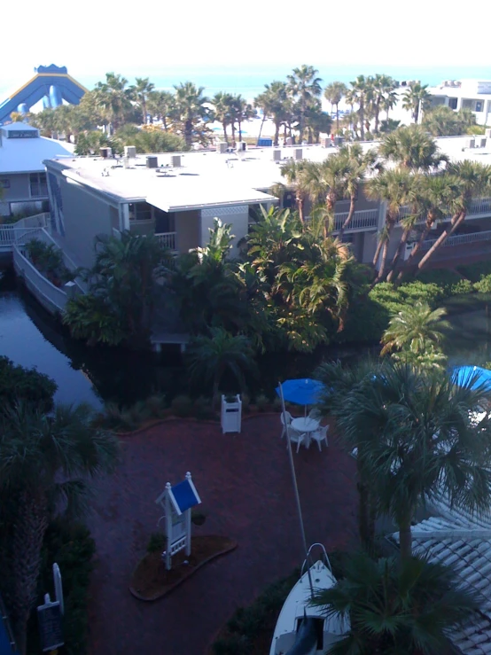 a house on a beach next to palm trees