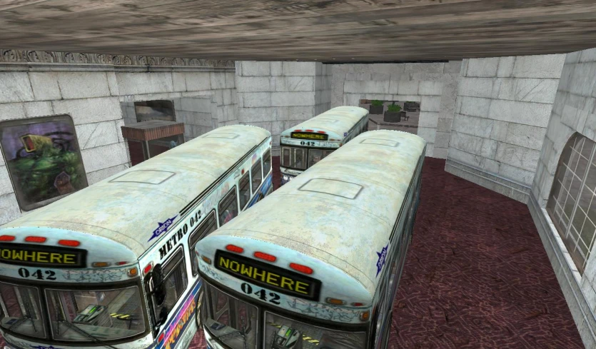 two buses parked next to each other in a building