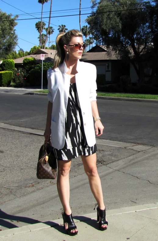 a woman with a handbag walking down the street