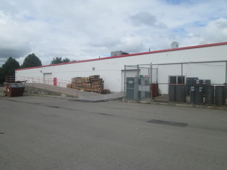 a po looking at the side of a building that is behind a large pile of crates