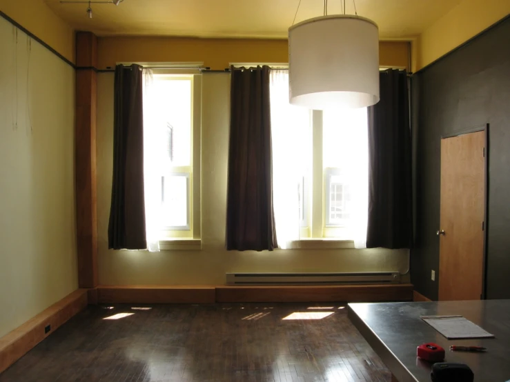 a room with several windows and a lamp