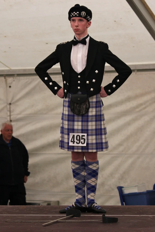 a man in a kilt poses for a po