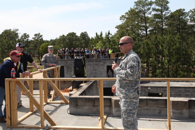 men standing in front of a wooden area