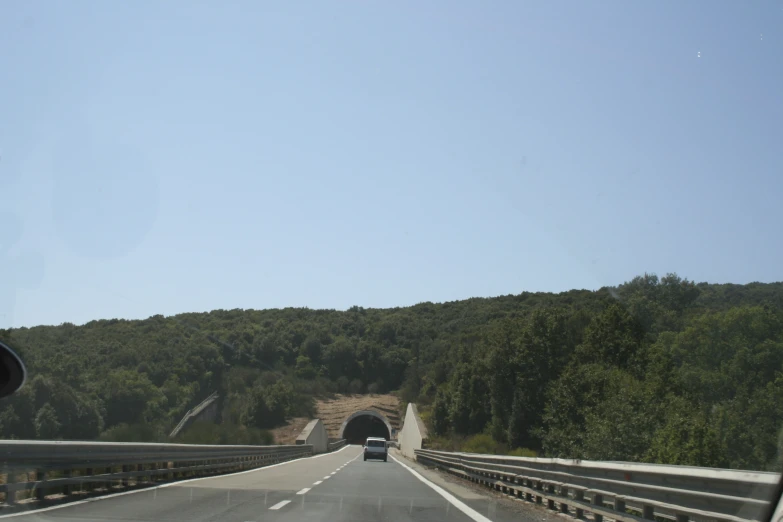 a view of the side of a highway from inside the car