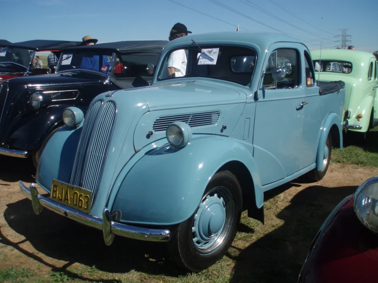 blue antique car in group at a show