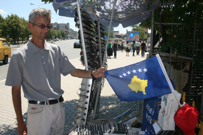 a man holding a flag under an umbrella