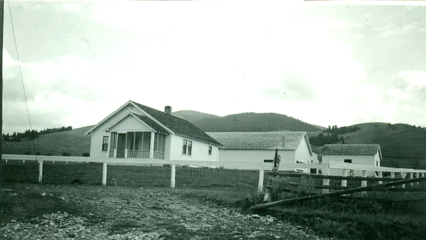 a house on a hillside with a fence