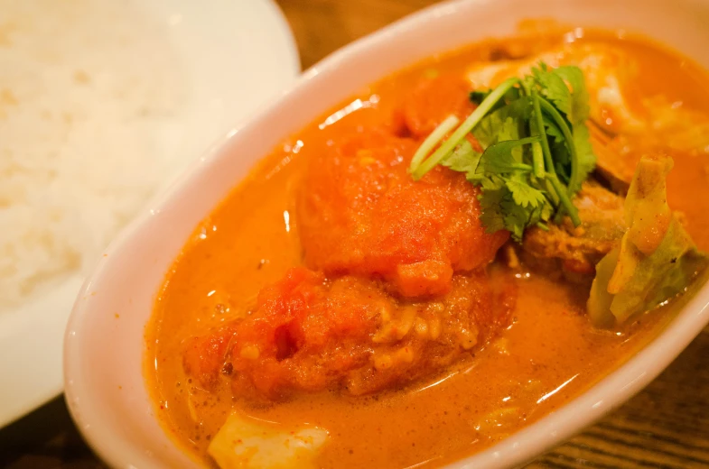 a plate with stew and rice in it