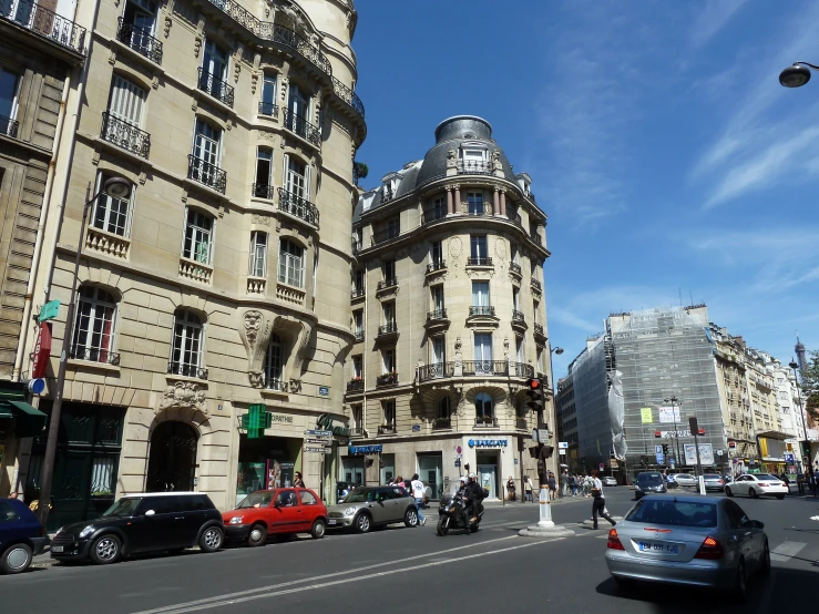 street scene of a town with old buildings and traffic