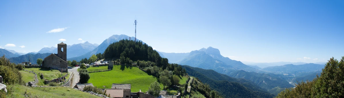 a small church on top of a green hill