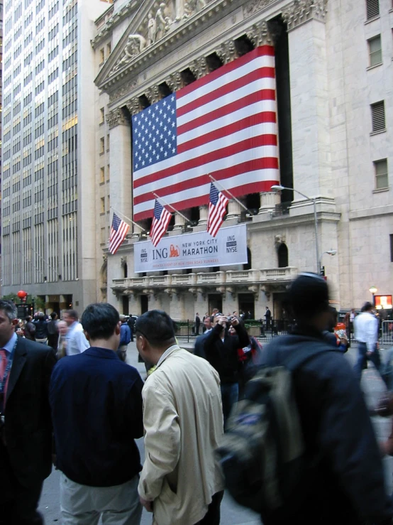 men standing on the street in front of the new york stock exchange