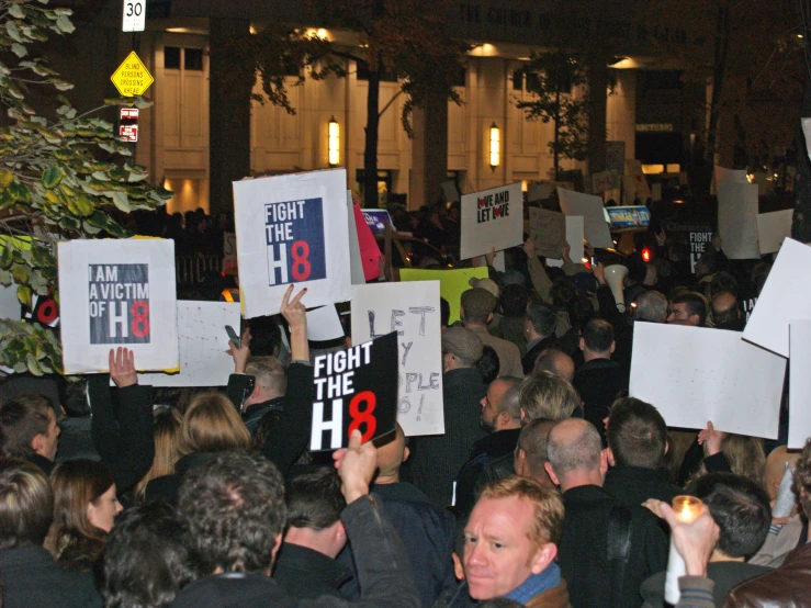 a bunch of people holding up signs in protest