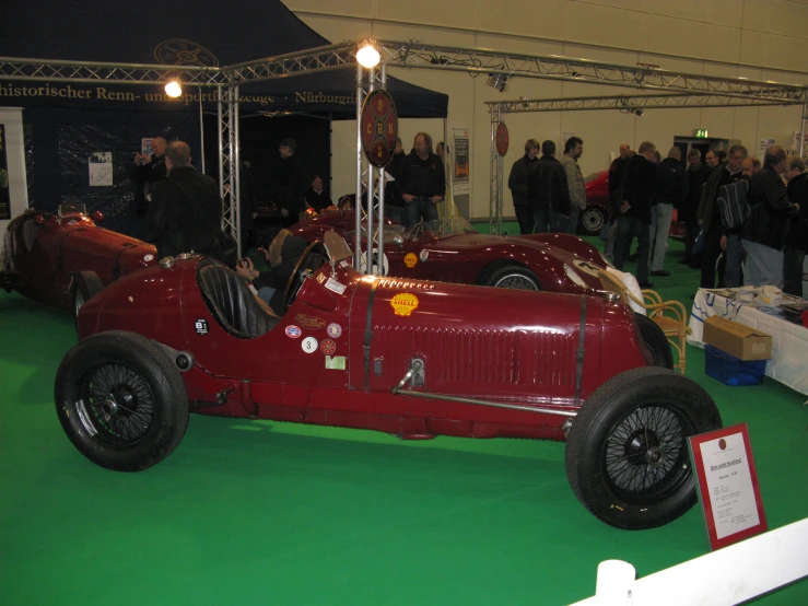red sports car on display at a vehicle show