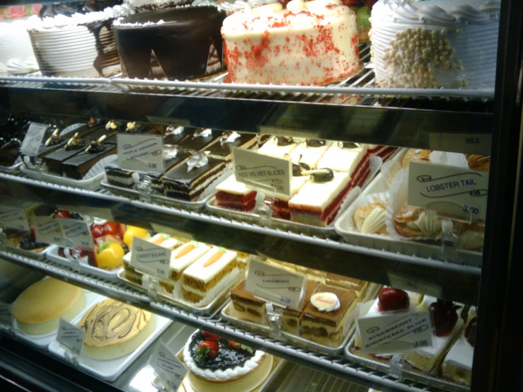 a variety of pastries are arranged on glass