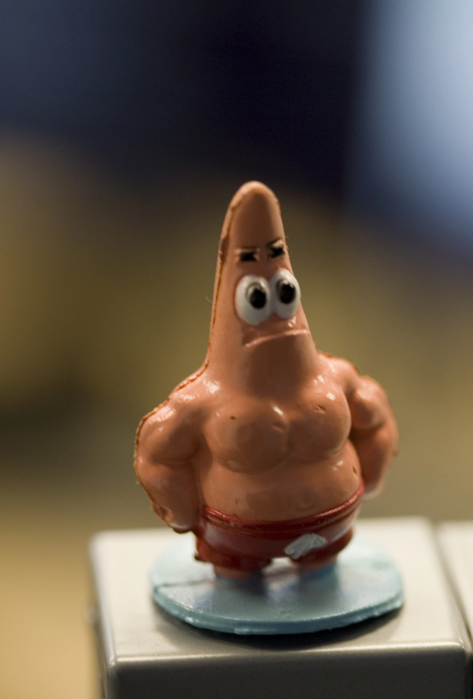 a brown toy sitting on top of a white plastic box