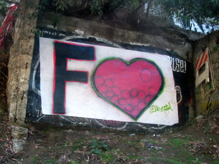 graffiti on the side of a wall depicting the f for fudge