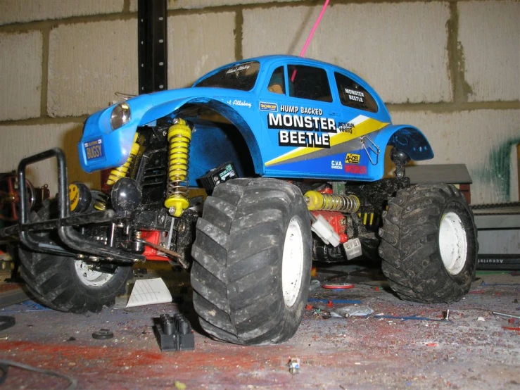 a blue monster truck sitting in a garage