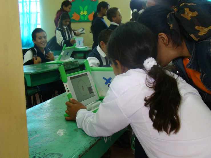 two s play with children's electronics at their desks