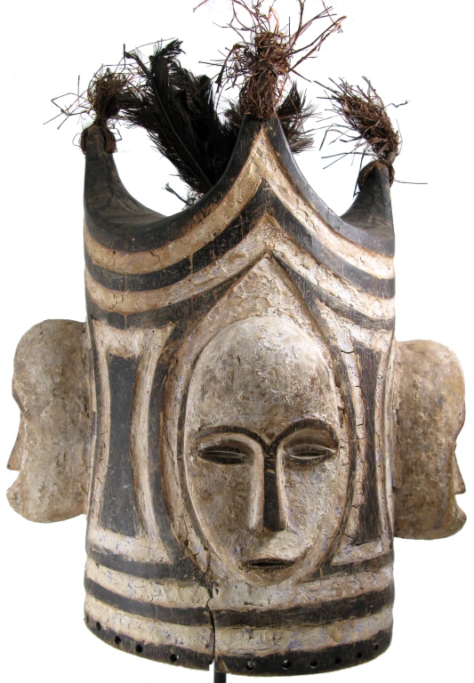 a face vase in the shape of an egyptian head with flowers on its head