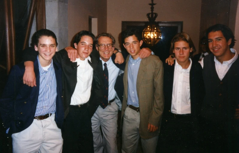 a group of young men dressed in ties and jackets posing for a po