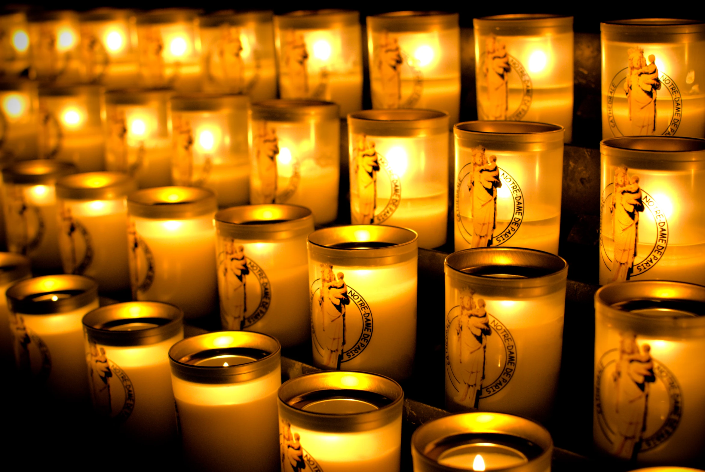 lit candles on display, with chinese writing