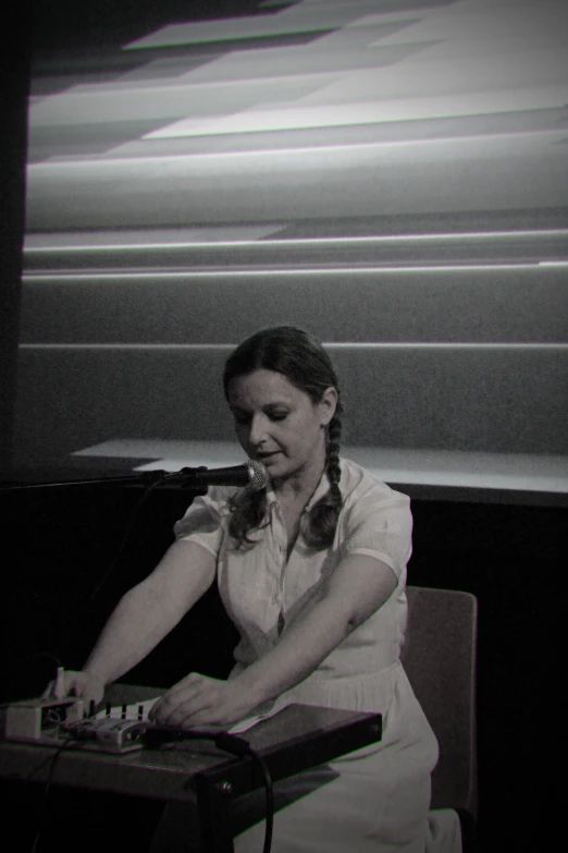 a woman in white dress playing with a controller