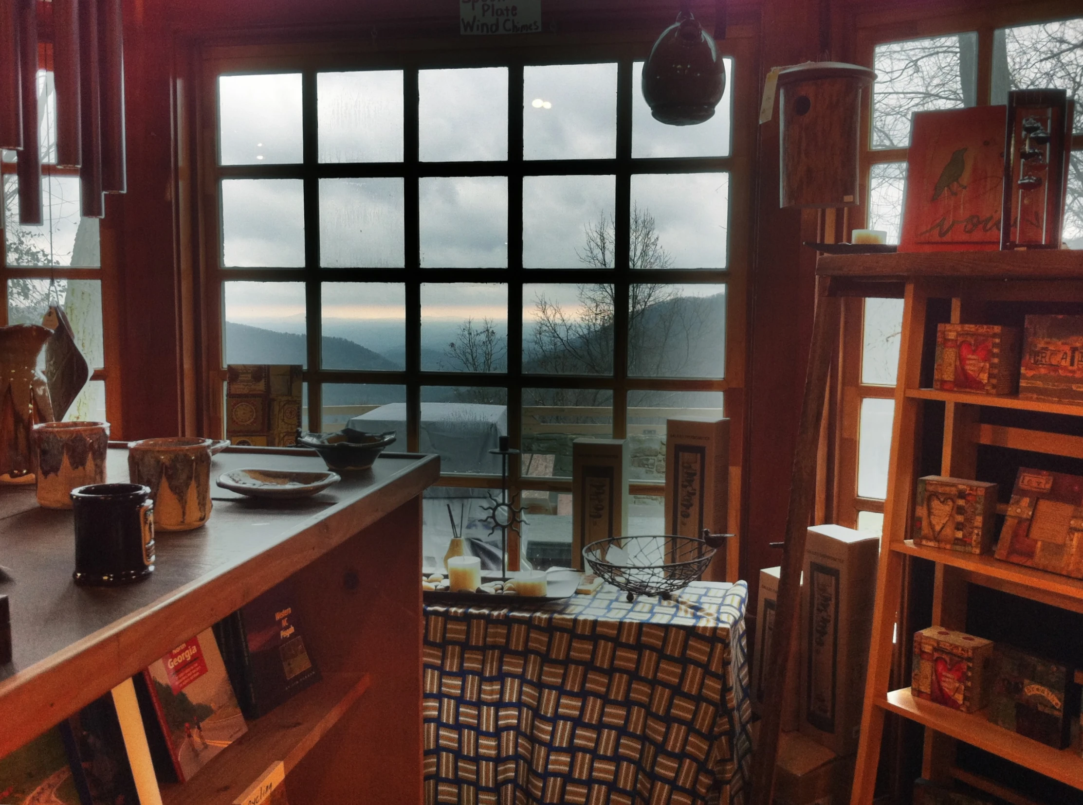 a kitchen filled with a table and a couple of shelves