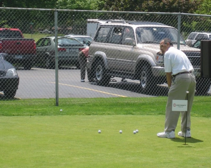 a man is preparing his putt at the golf course