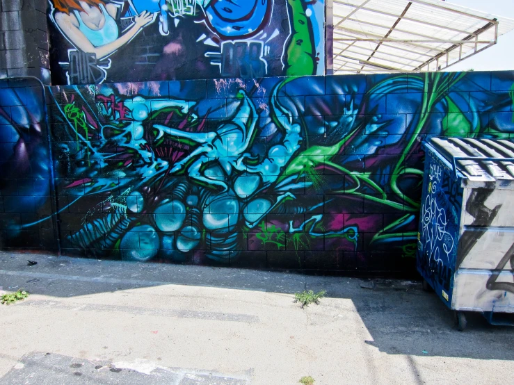 an outdoor structure has graffiti and trash on it