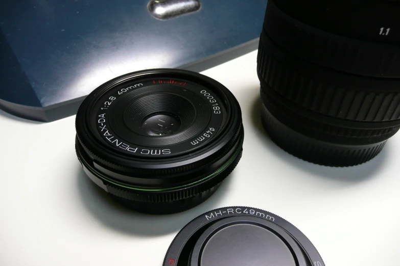 a camera lens sitting on a desk next to a cup of coffee