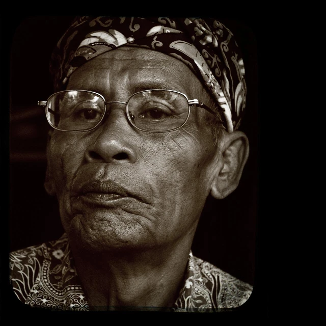 a black and white po of an old person with glasses