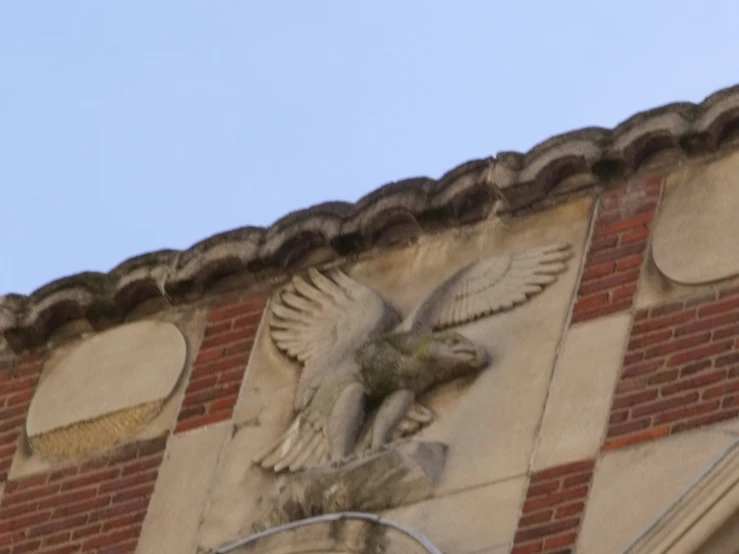 the top of the building shows an intricate sculpture of a bird