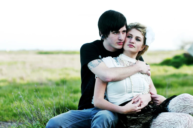 two people posing in a field and one man has his eyes closed