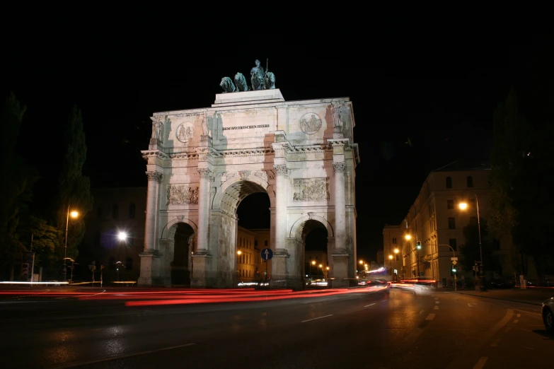 an illuminated arch is pictured during the night time