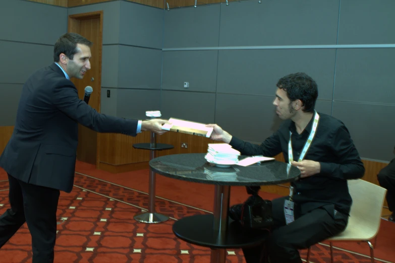 a person handing another persons hand food to someone