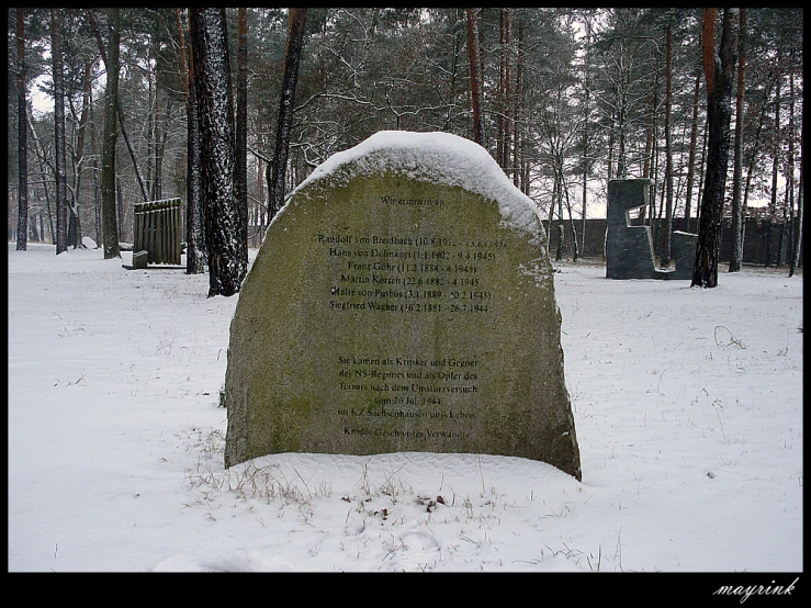 the snow covered grave has an inscription on it